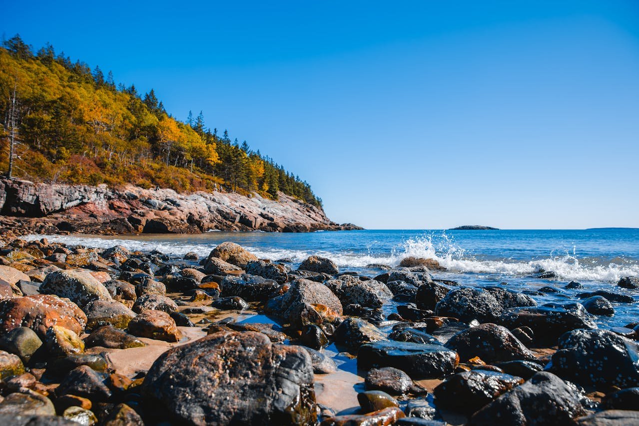 Maine lighthouse and rocky coastal landscape